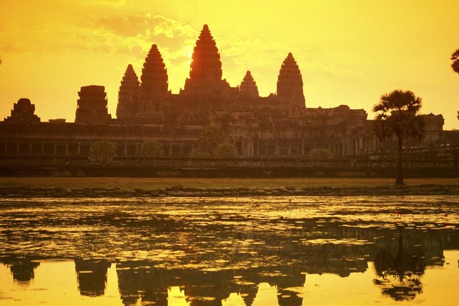 Angkor Wat towers in silhouette at sunrise