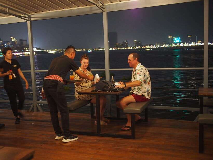 Phnom Penh: Mekong Sunset Dinner Cruise with Live Music - Sunset views, rain, and comfort onboard