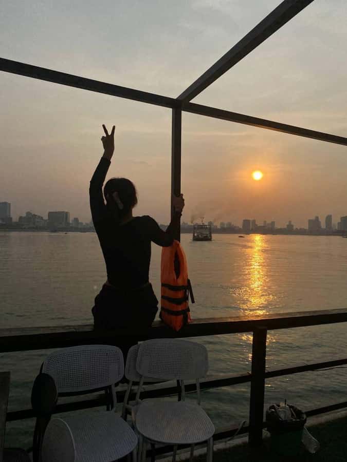 Phnom Penh: Sunset Cruise with Unlimited Beers & BBQ Buffet - Diamond Island Bridge and the Cambodian flag