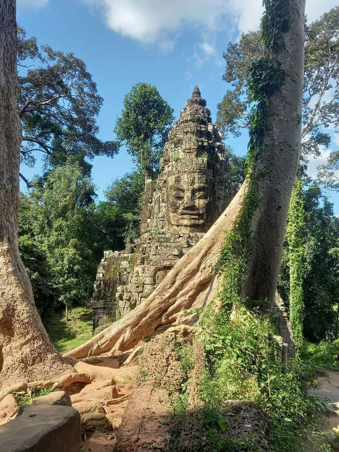 Shared day tour with Spanish-speaking guide at Angkor Temple. - Bayon and its enormous stone faces
