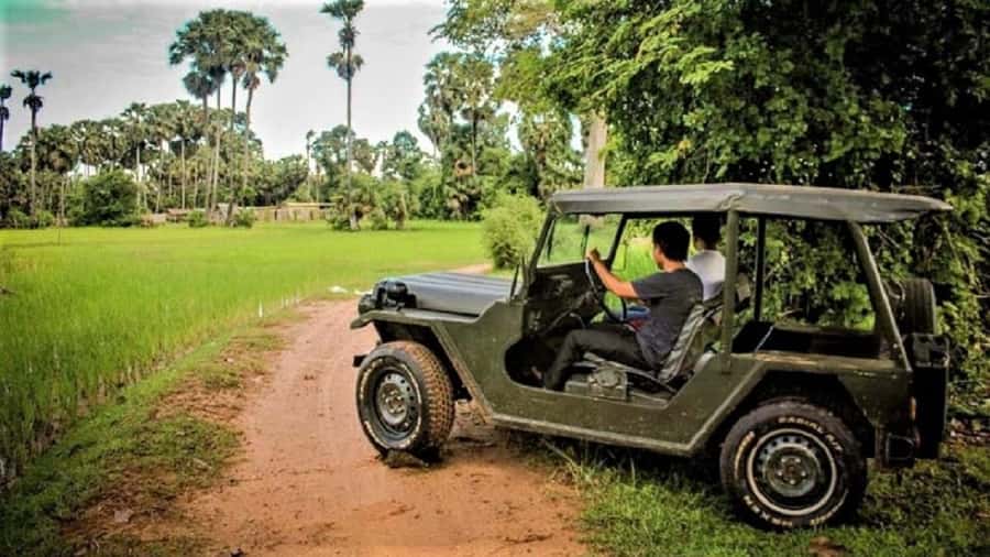 Siem Reap: Guided Countryside Sunset Tour by Jeep - Leaving Siem Reap in an open vintage jeep